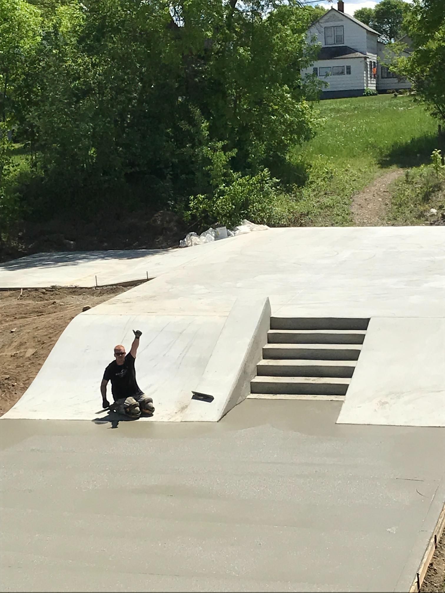 A man is riding a skateboard down a ramp.