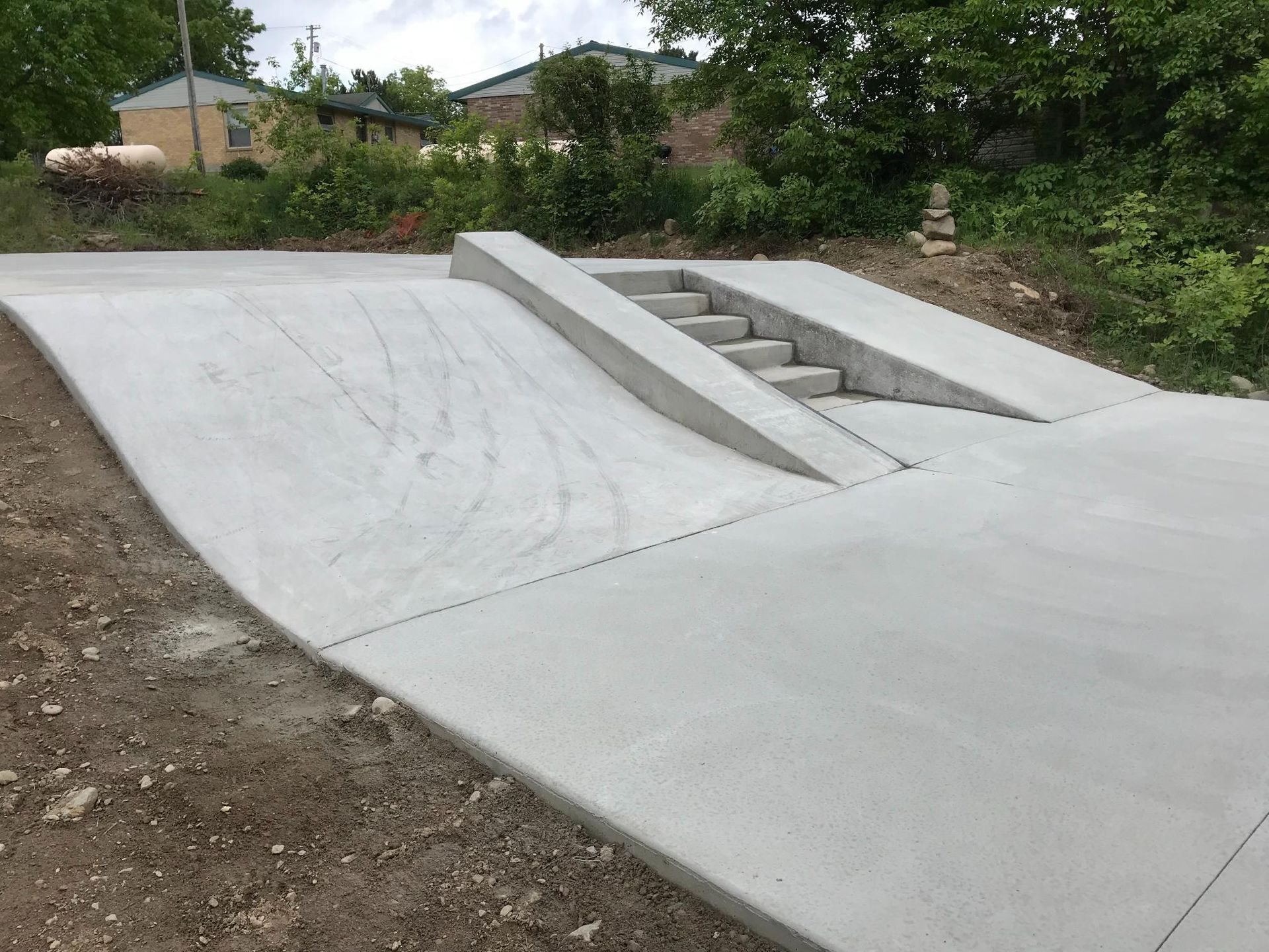 A concrete ramp with stairs on the side of it.