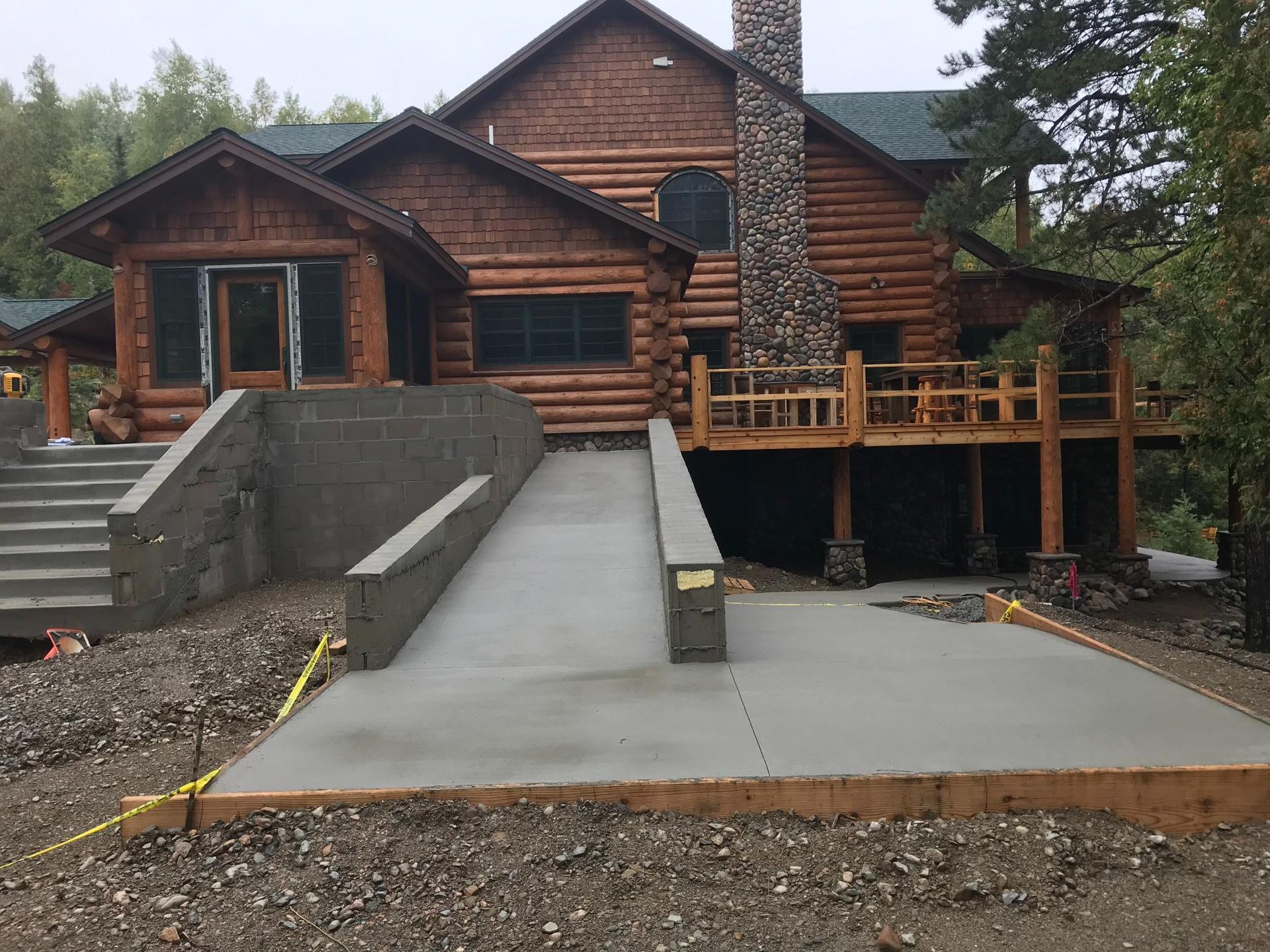 A large log cabin with a ramp leading to it