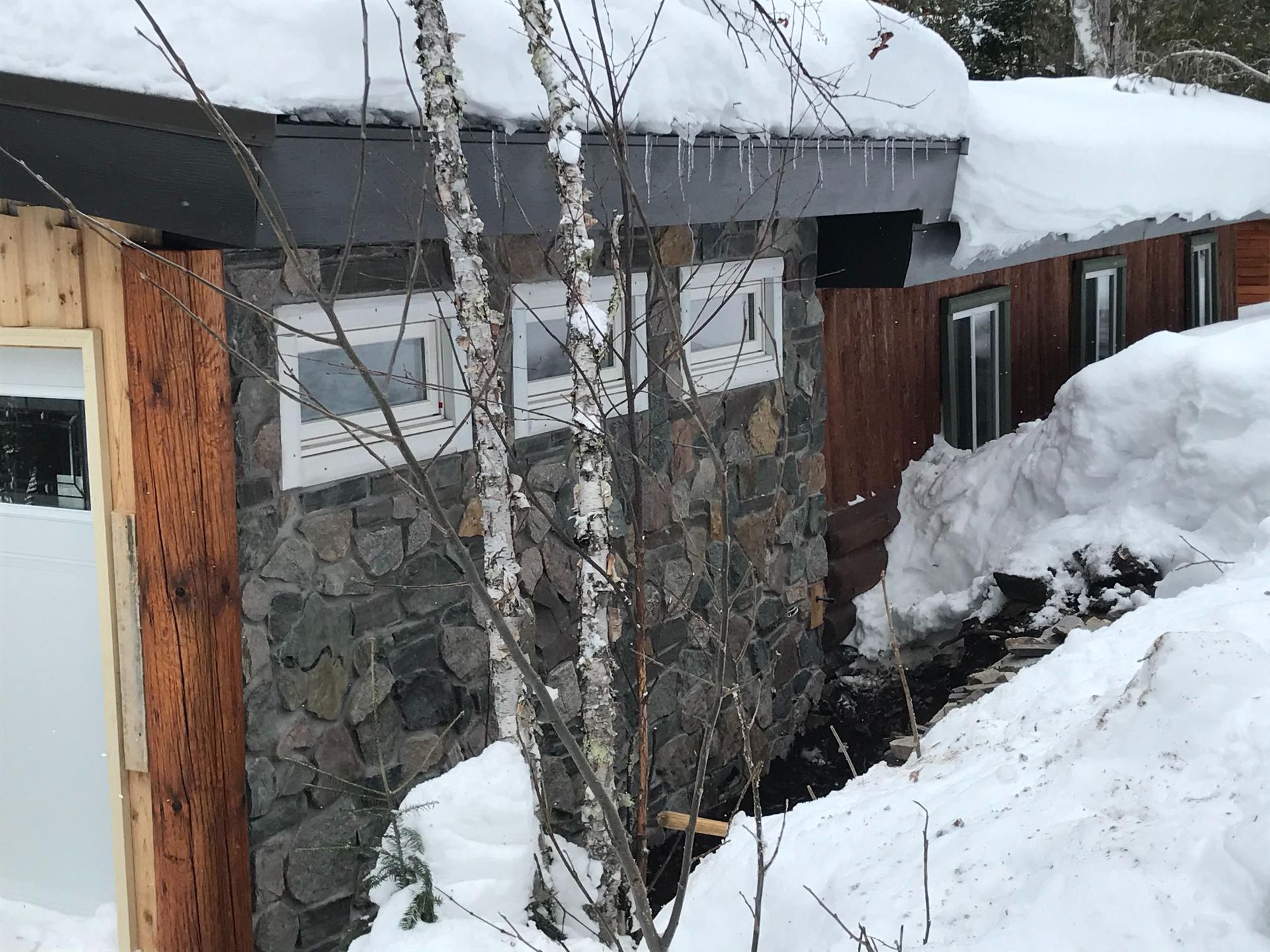 A house with a lot of snow on the roof