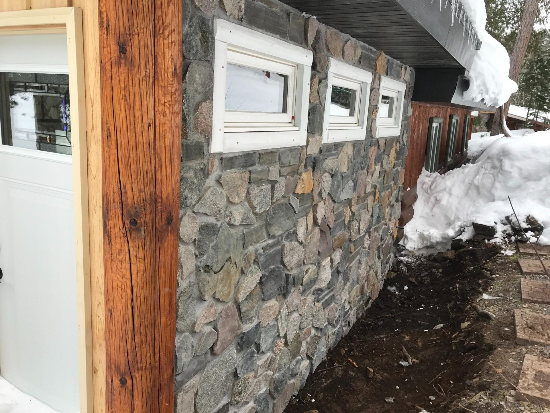A stone wall with a row of windows on it