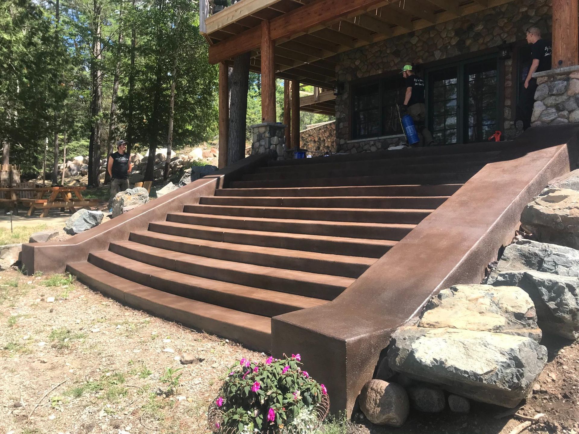 A set of stairs leading up to a house with trees in the background.