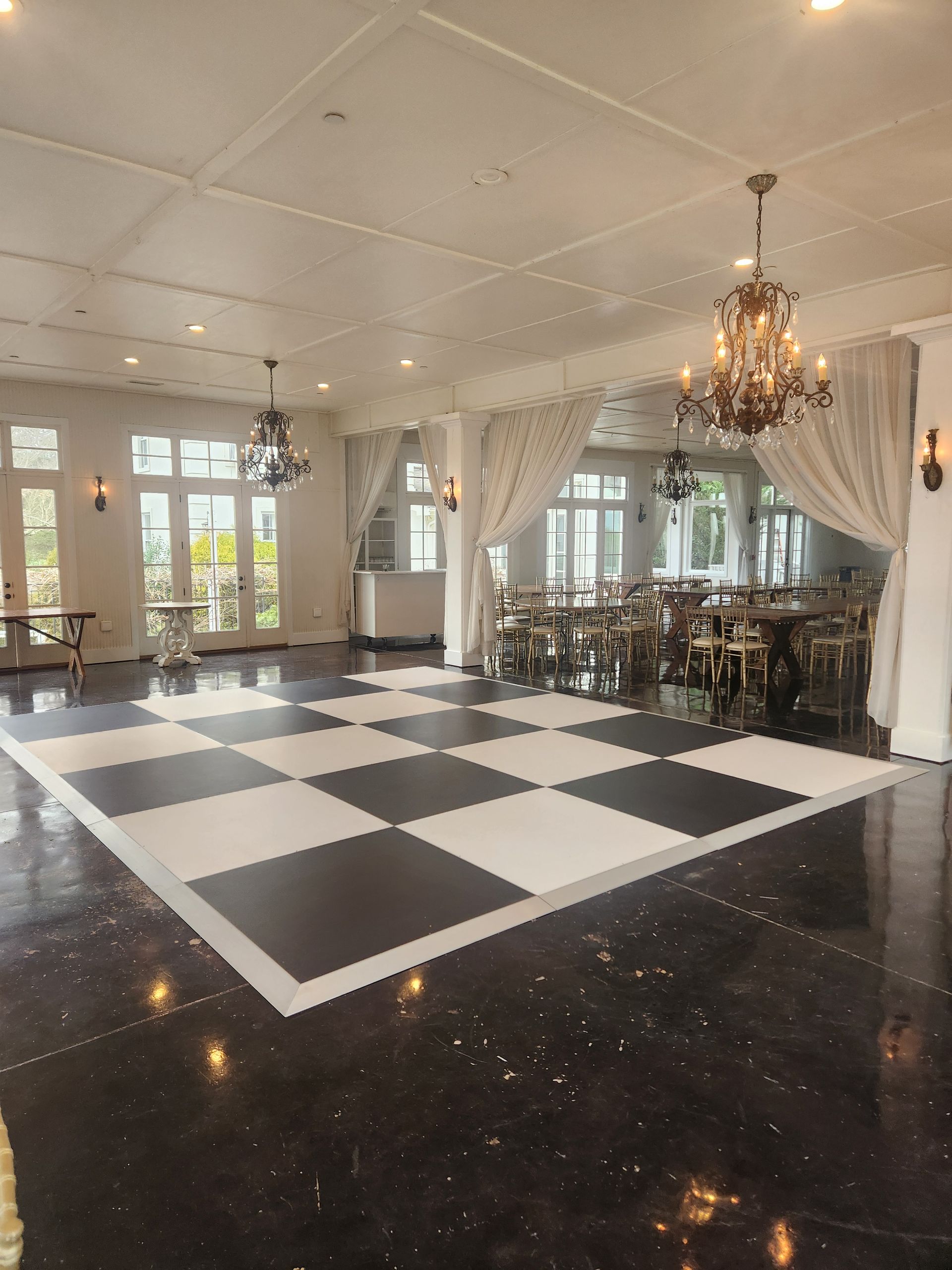 a large room with a black and white checkered dance floor