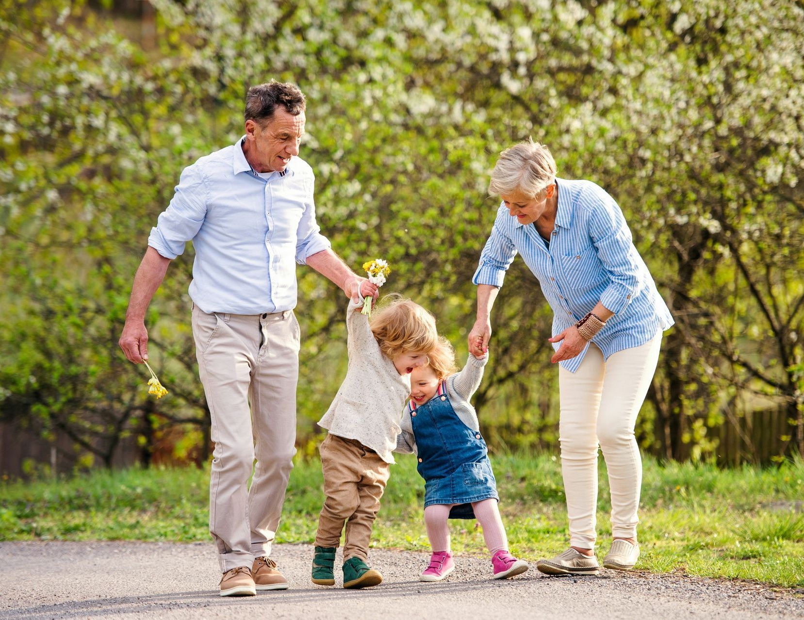 A woman in a red dress is standing on a beach looking at the ocean.