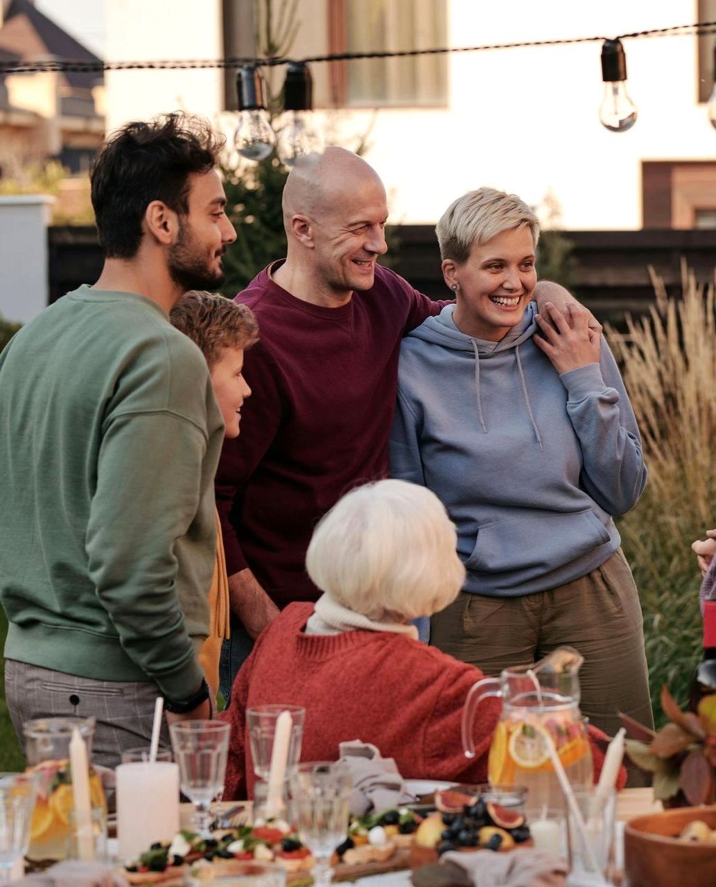 Three women are posing for a picture in front of a body of water.