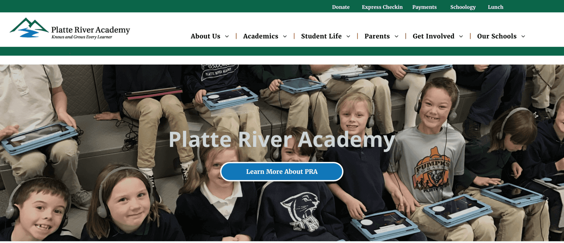 A website for platte river academy shows a group of children wearing headphones