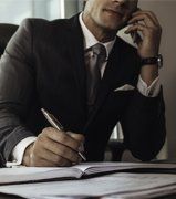 Professional Bond Agent — Attorney Talking on Phone and Writing in Abingdon, VA