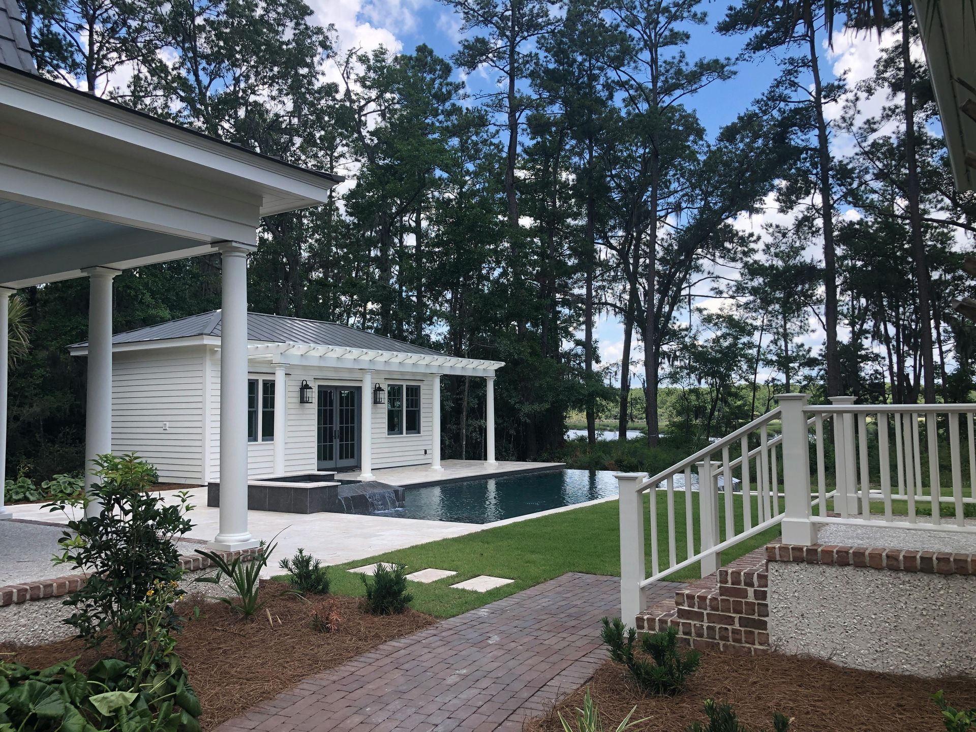 A white house with a swimming pool in the backyard