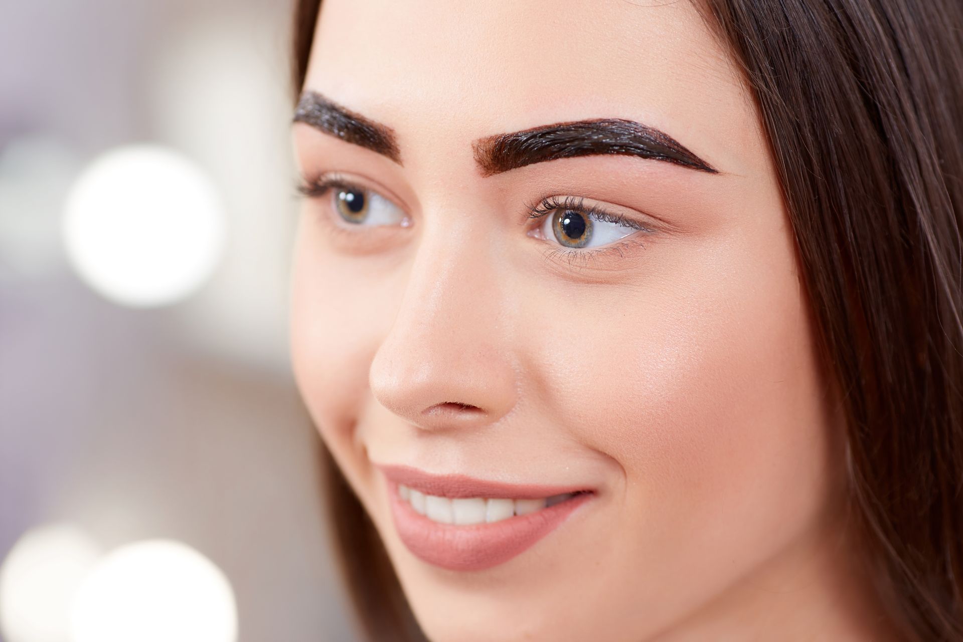 a close up of a woman 's face with  her eyebrows tinted.