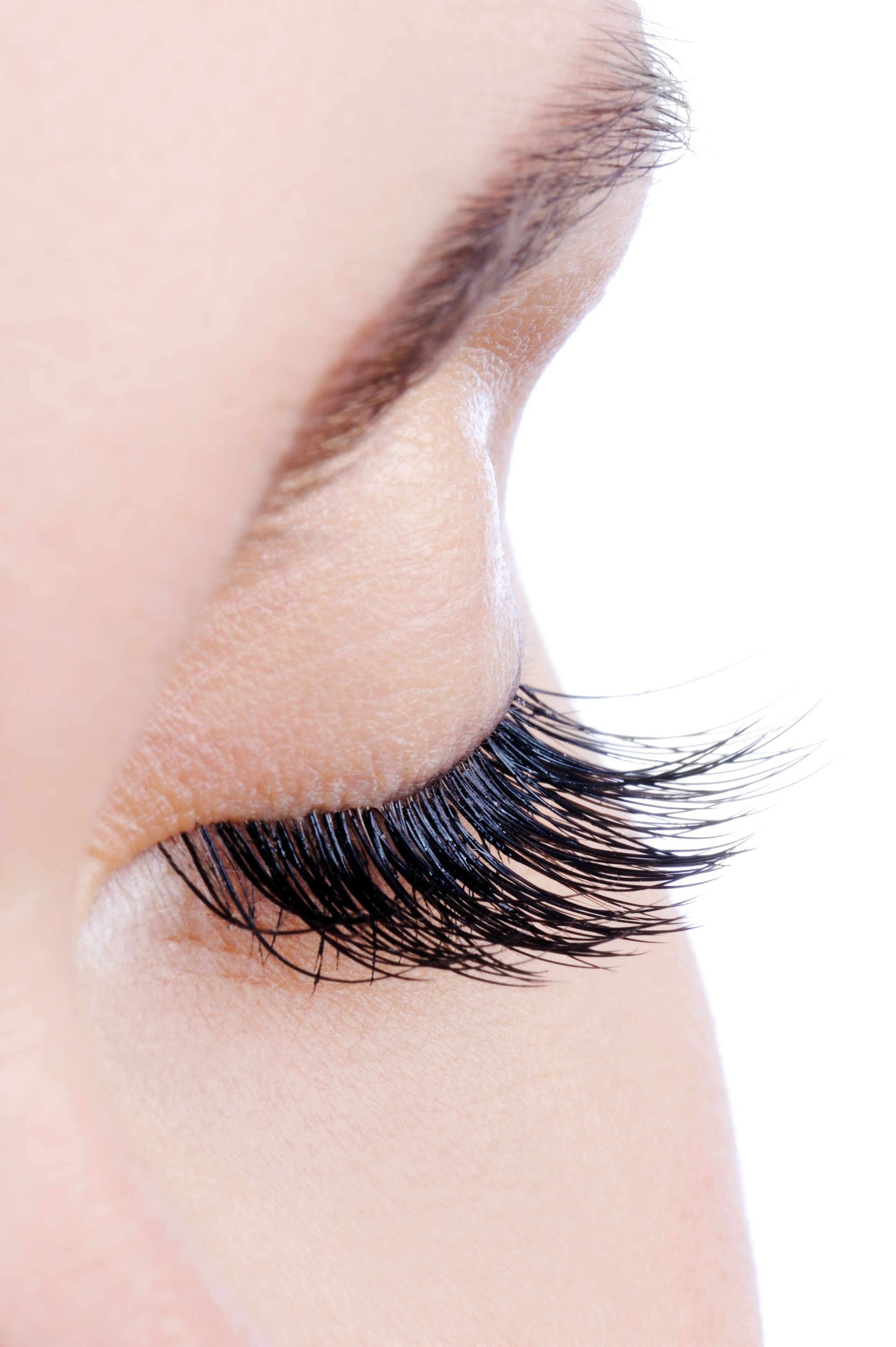 a close up of a woman 's eye with long eyelashes .