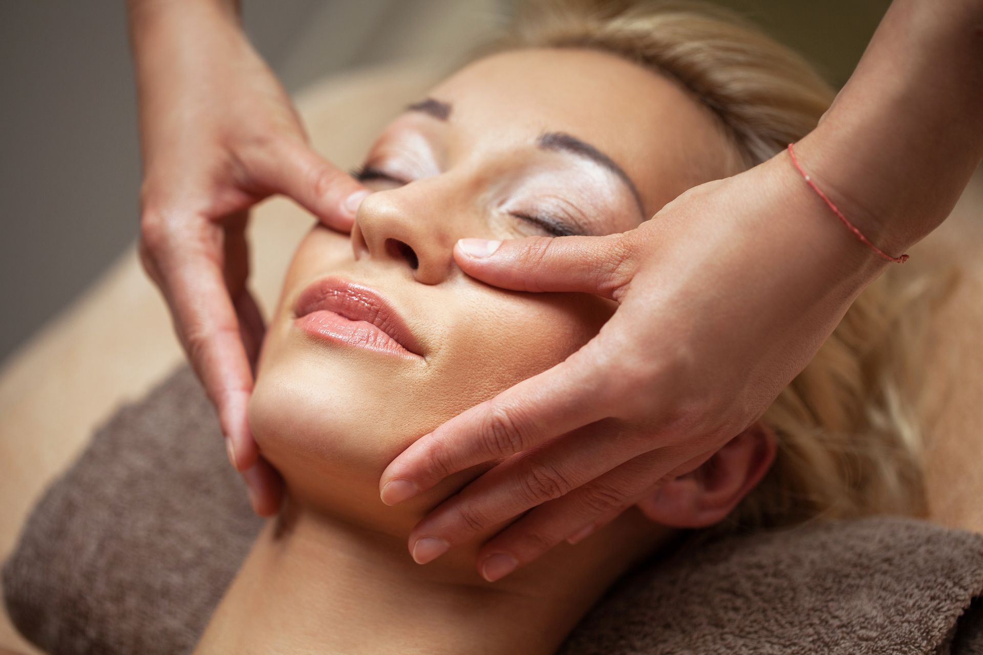 a woman is getting a facial massage at a spa .