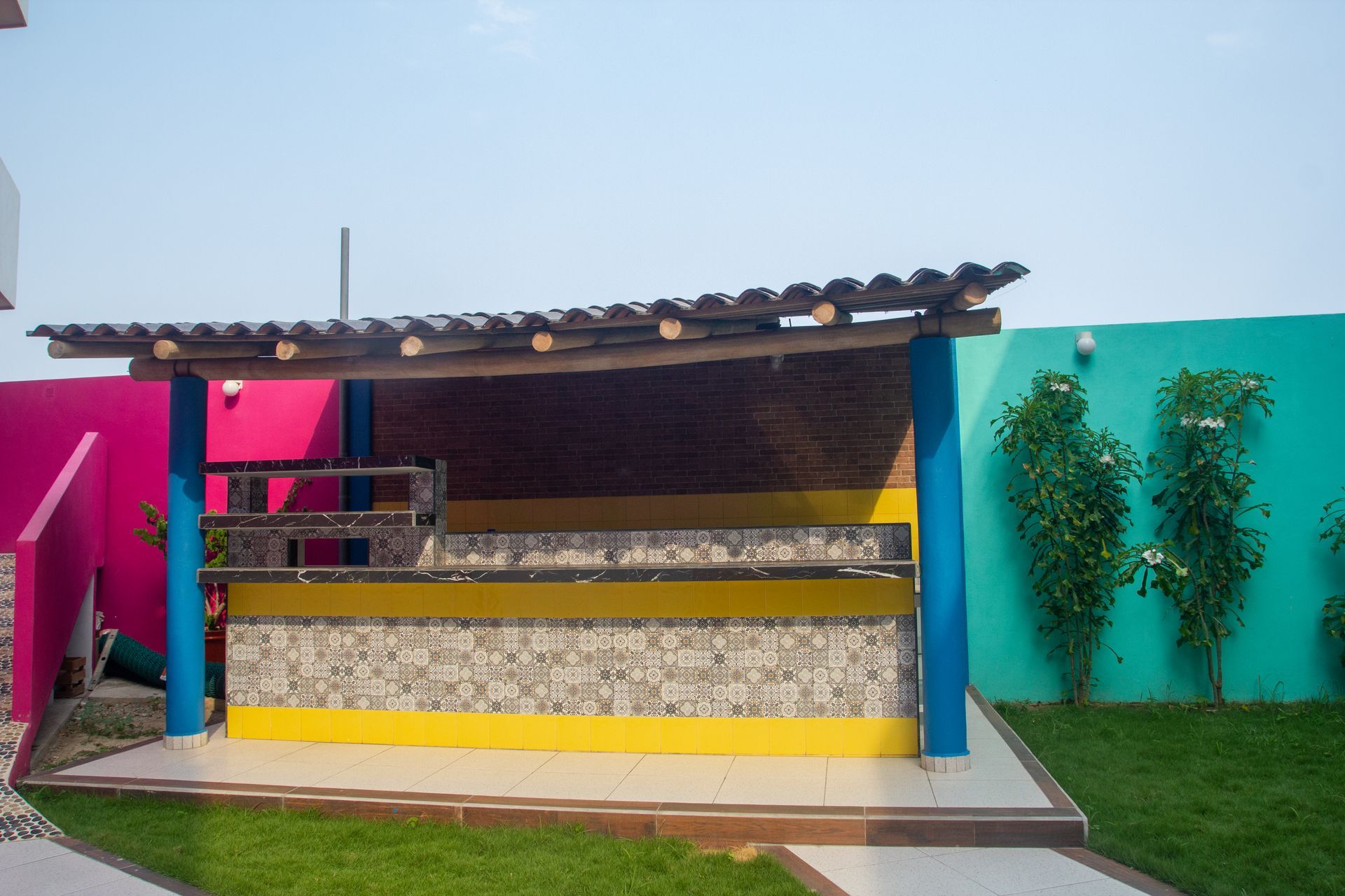A yellow and blue building with a wooden roof