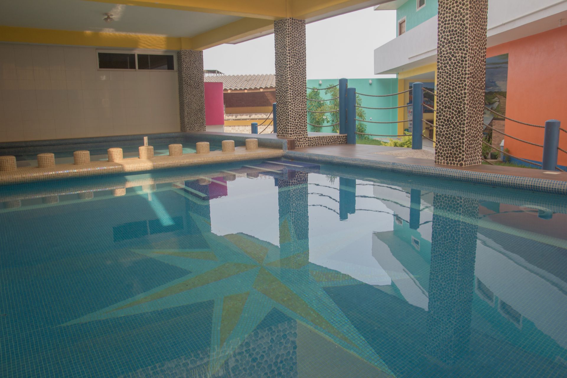 A large swimming pool surrounded by colorful buildings