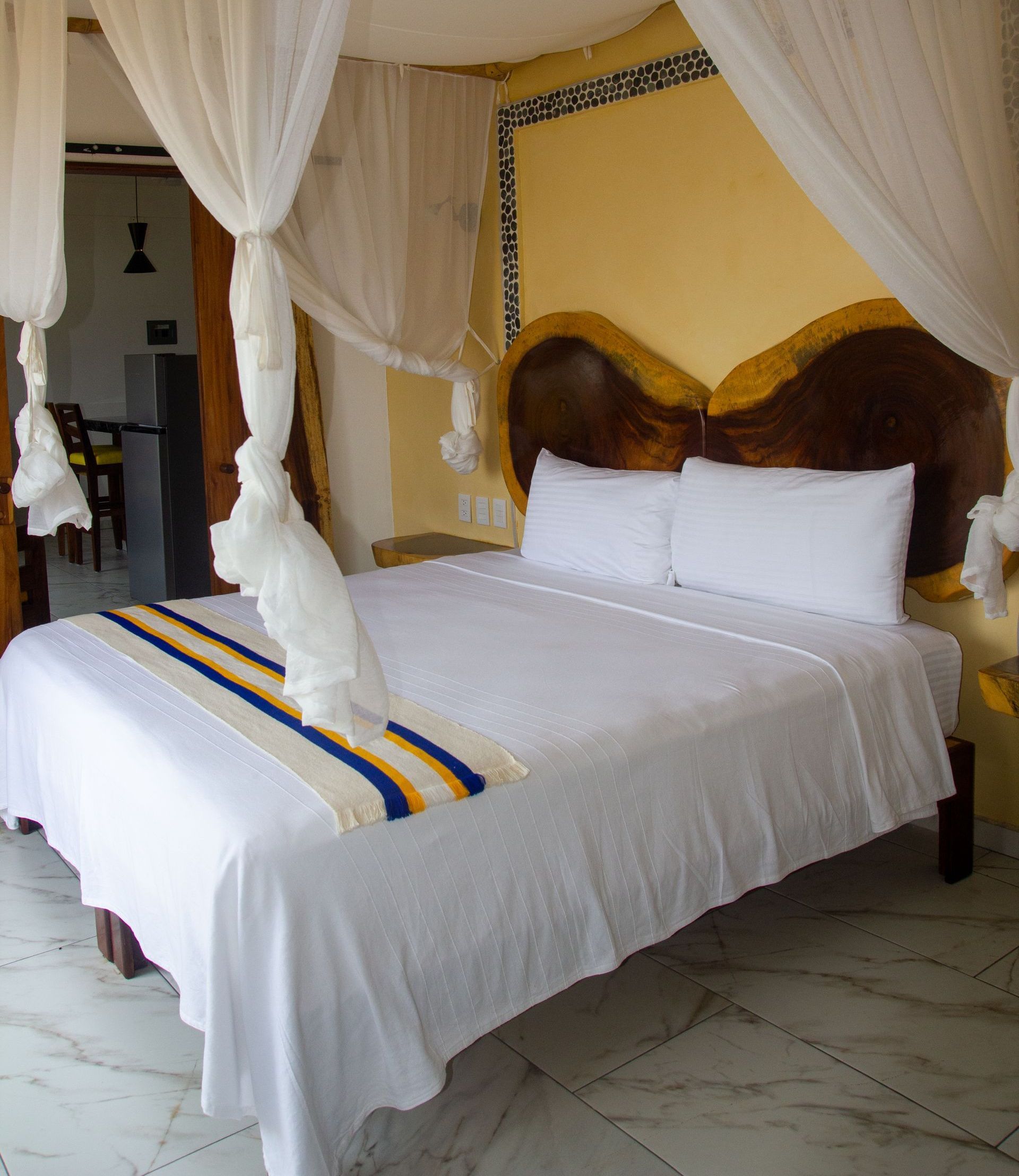 A bed with a canopy in a hotel room
