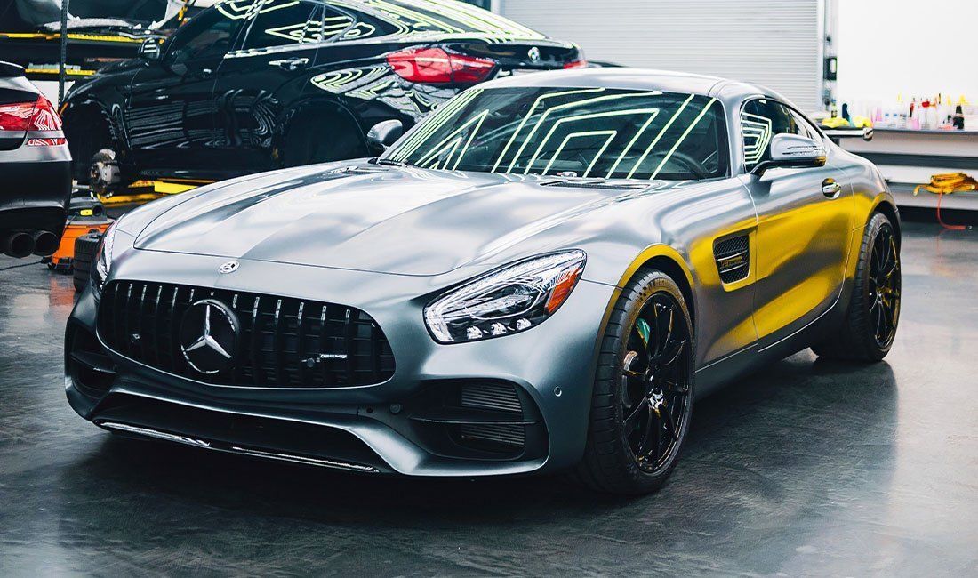 A mercedes amg gt is parked in a garage.