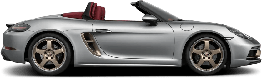 A silver porsche boxster convertible with a red top on a white background.