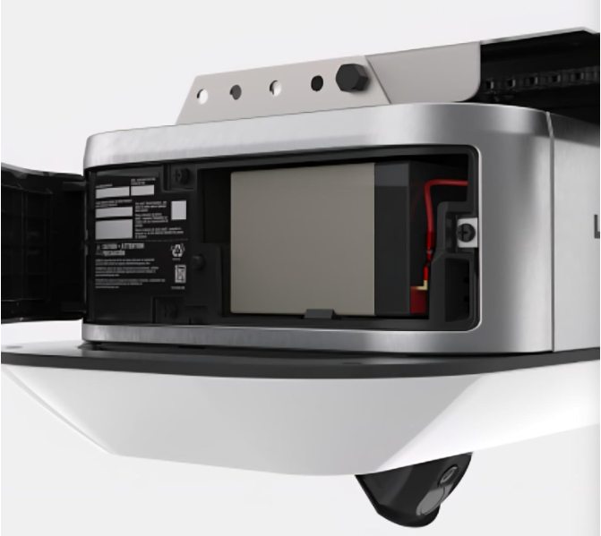 Battery compartment of a device, with battery visible. Compartment is open.