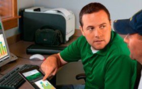 man with tablet demonstrating software