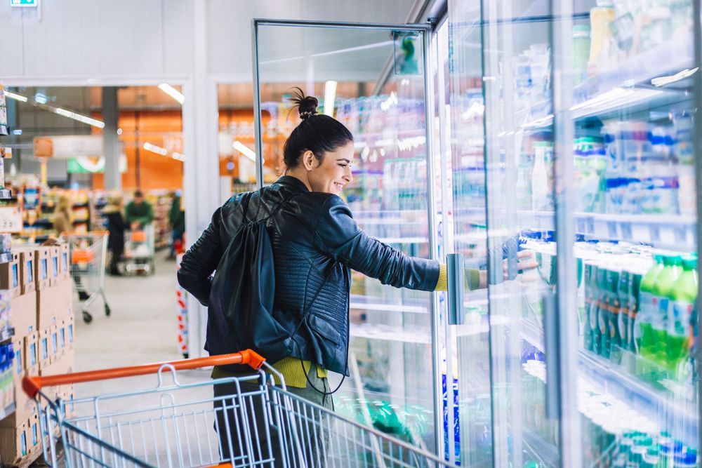 Young Woman Shopping In Supermarket — Bradenton, FL — Comfort Kings Heating  Cooling & Refrigeration