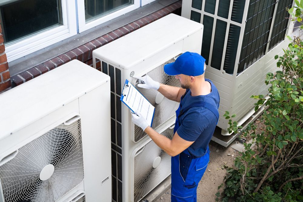 Electrician Checking On Air Conditioning Unit — Bradenton, FL — Comfort Kings Heating  Cooling & Refrigeration