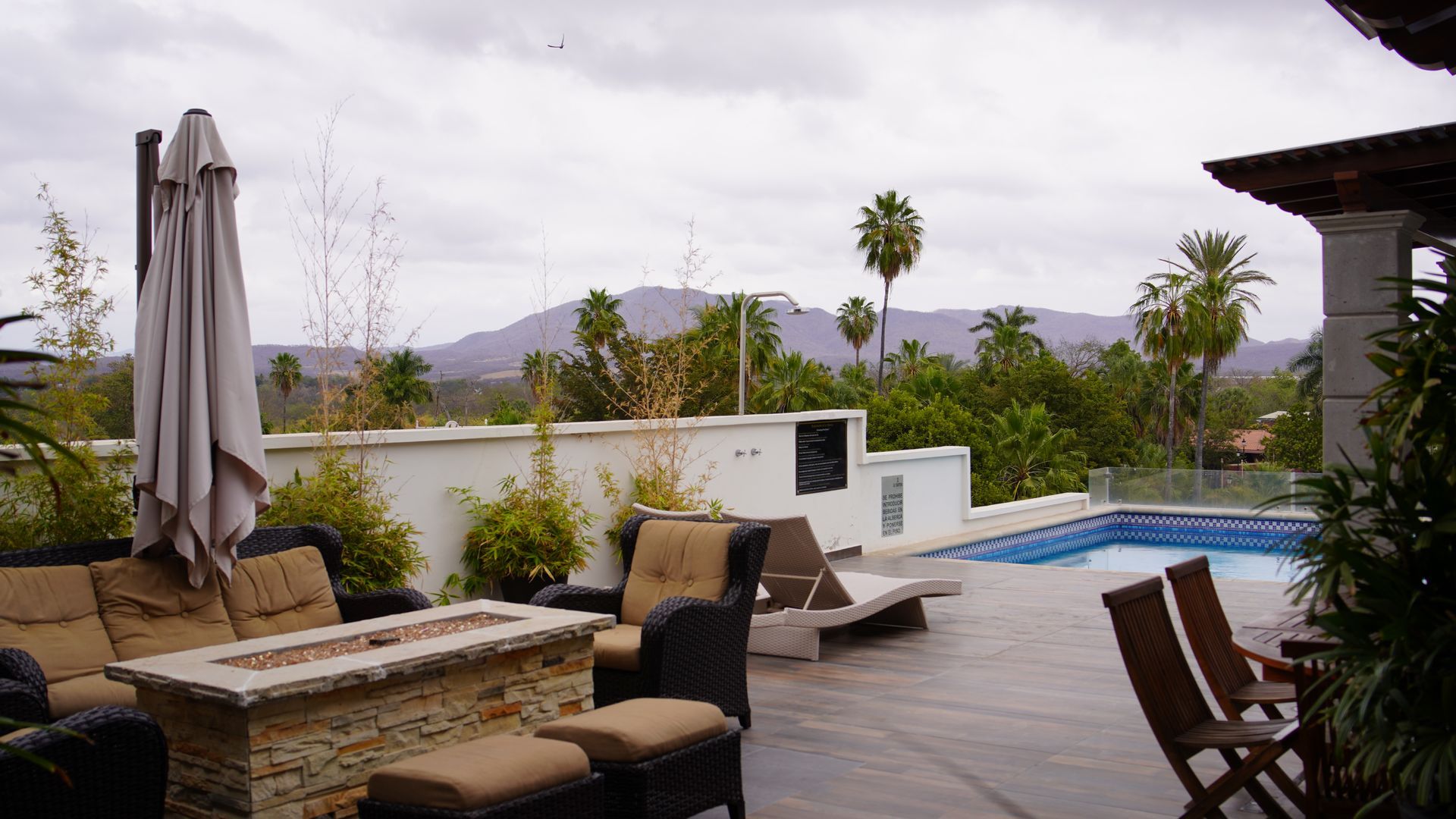 A patio with a fire pit and a swimming pool