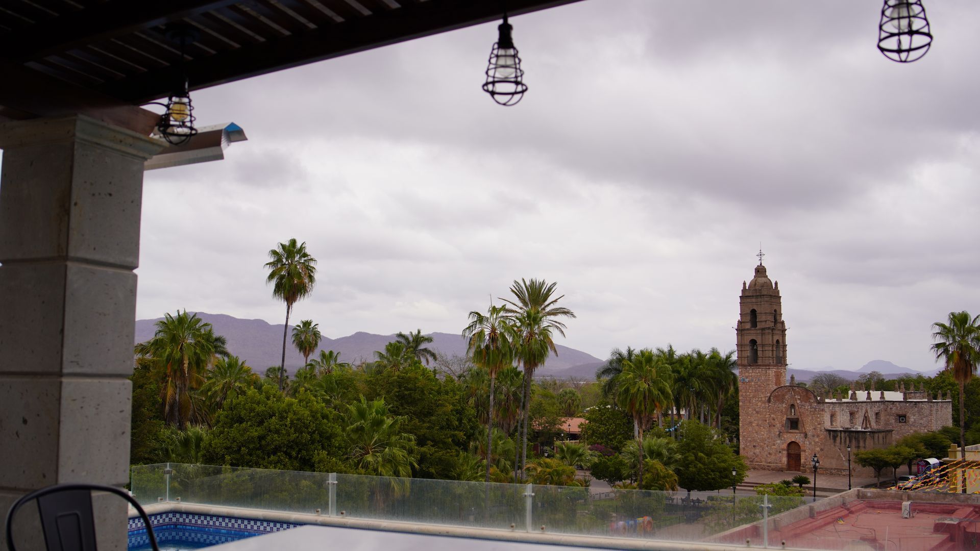 A view of a swimming pool with a church in the background
