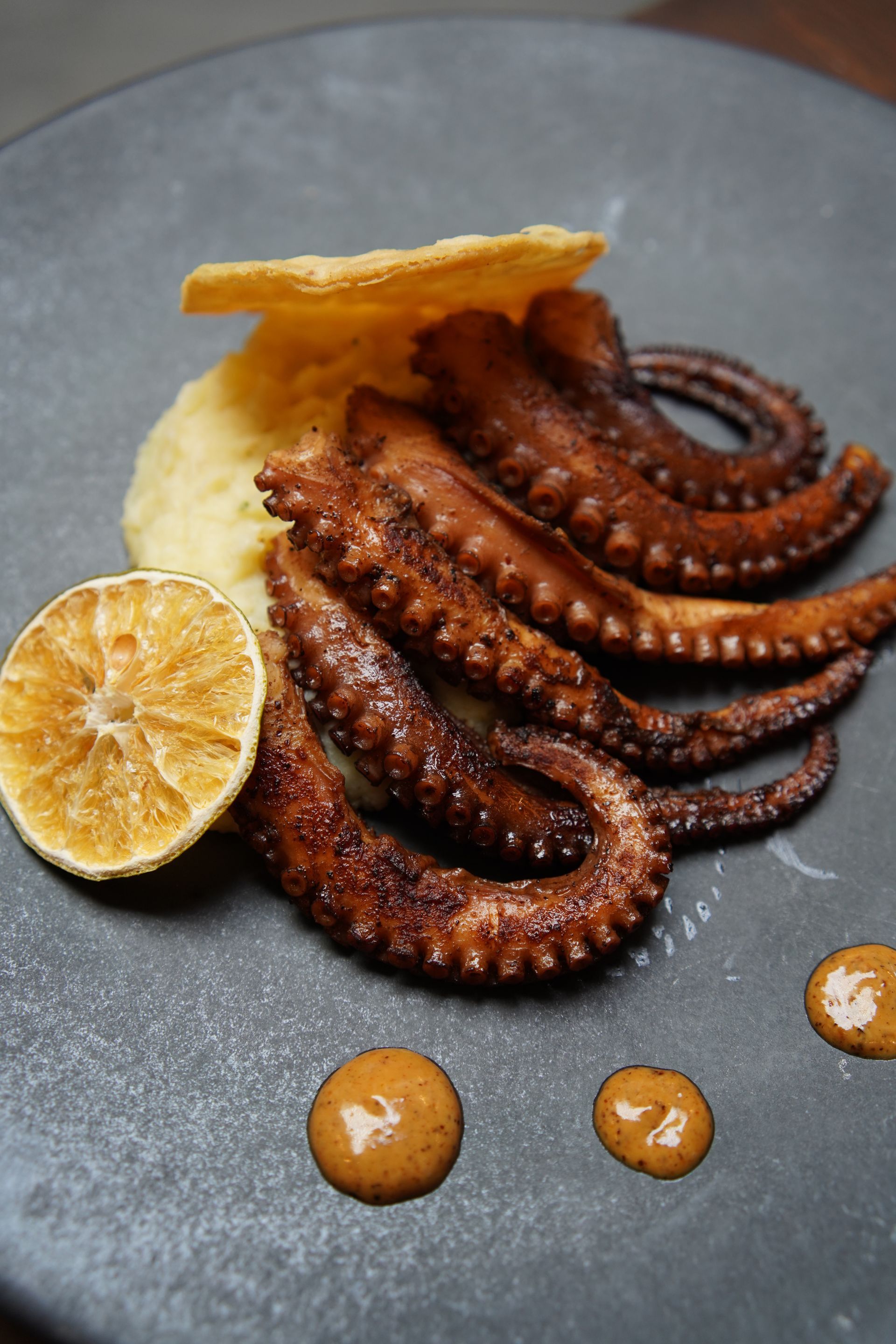 A close up of a plate of food with an octopus on it