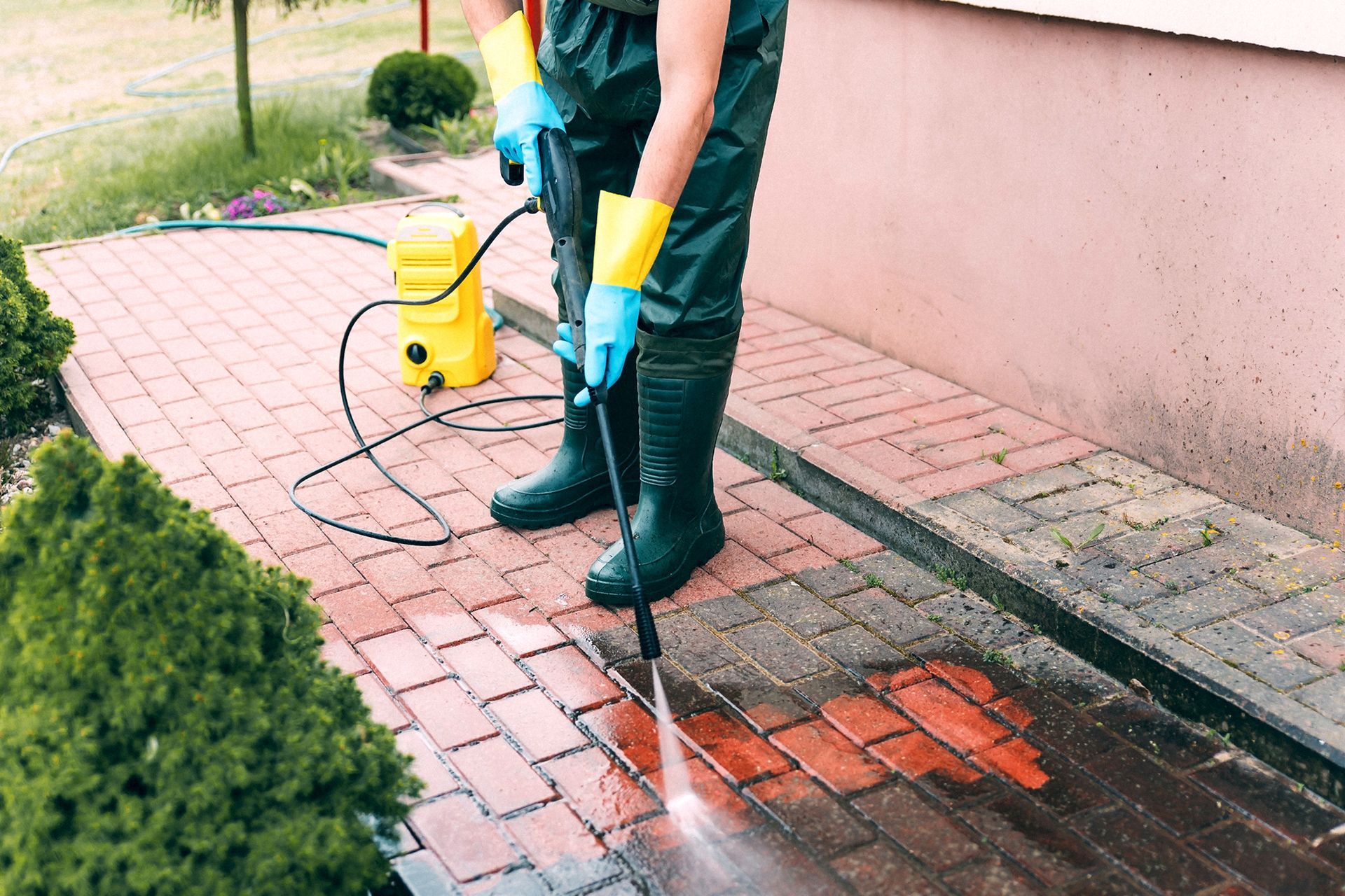 Person Using High Pressure Washer to Clean the Sidewalk