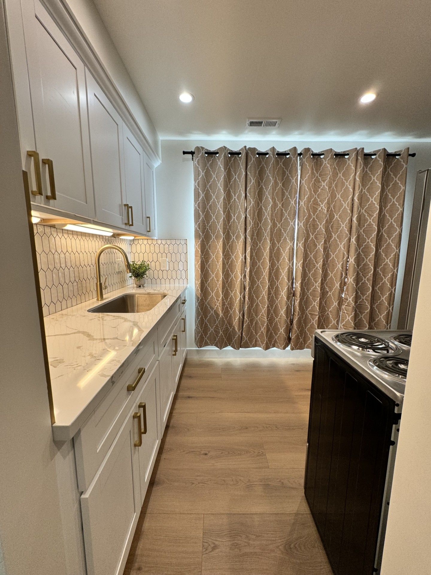 A bathroom with a claw foot tub and a stained glass window.