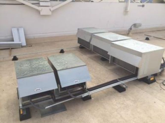 A wooden deck with stairs leading up to it is in front of a house.