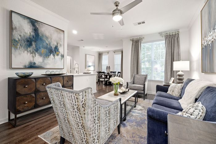 Swimming pool with palm trees and brick patio.