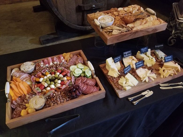 Three trays of food are sitting on a table.