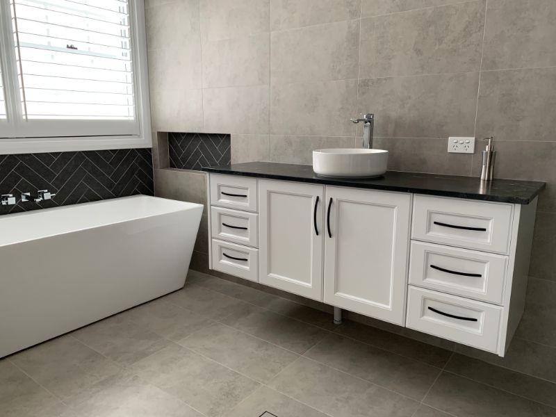 White Bathtub Next to Bathroom Sink — Innovative Design in Salamander Bay, NSW