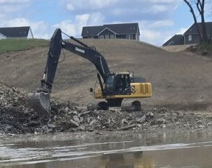 Excavator digging a residential foundation