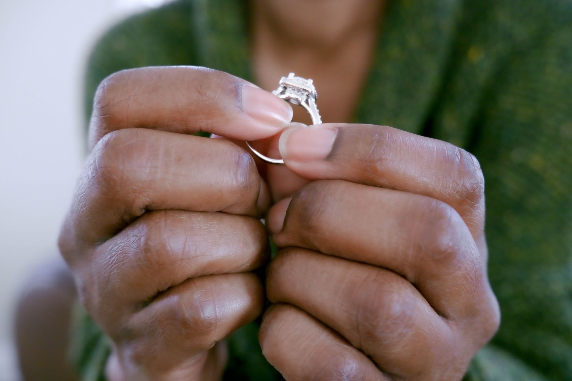 Close-up of unrecognizable black woman holding ring.