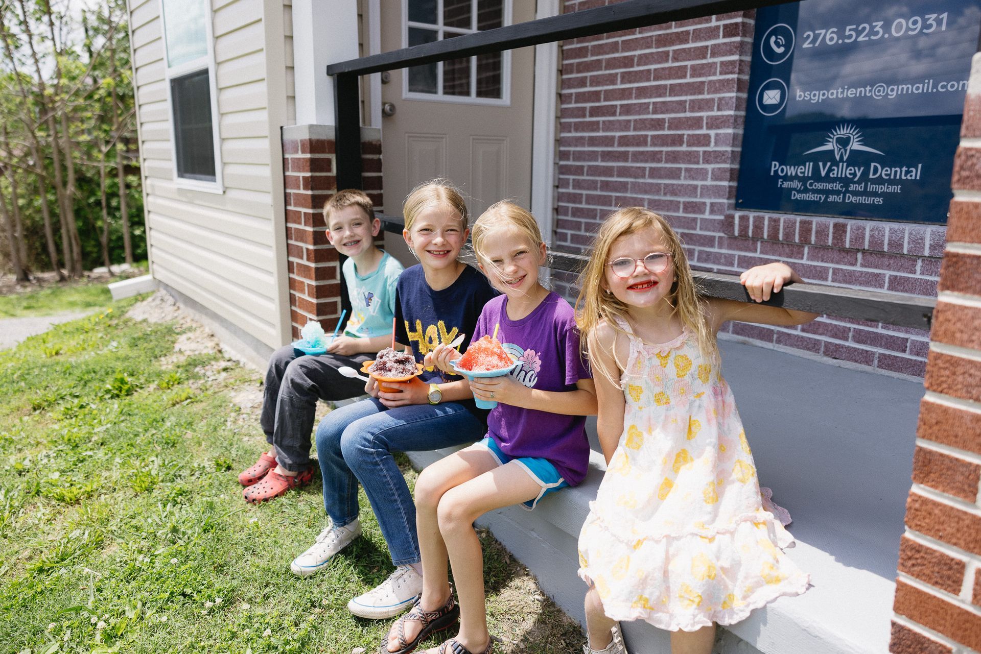 A group of women wearing dental shirts are posing for a picture.