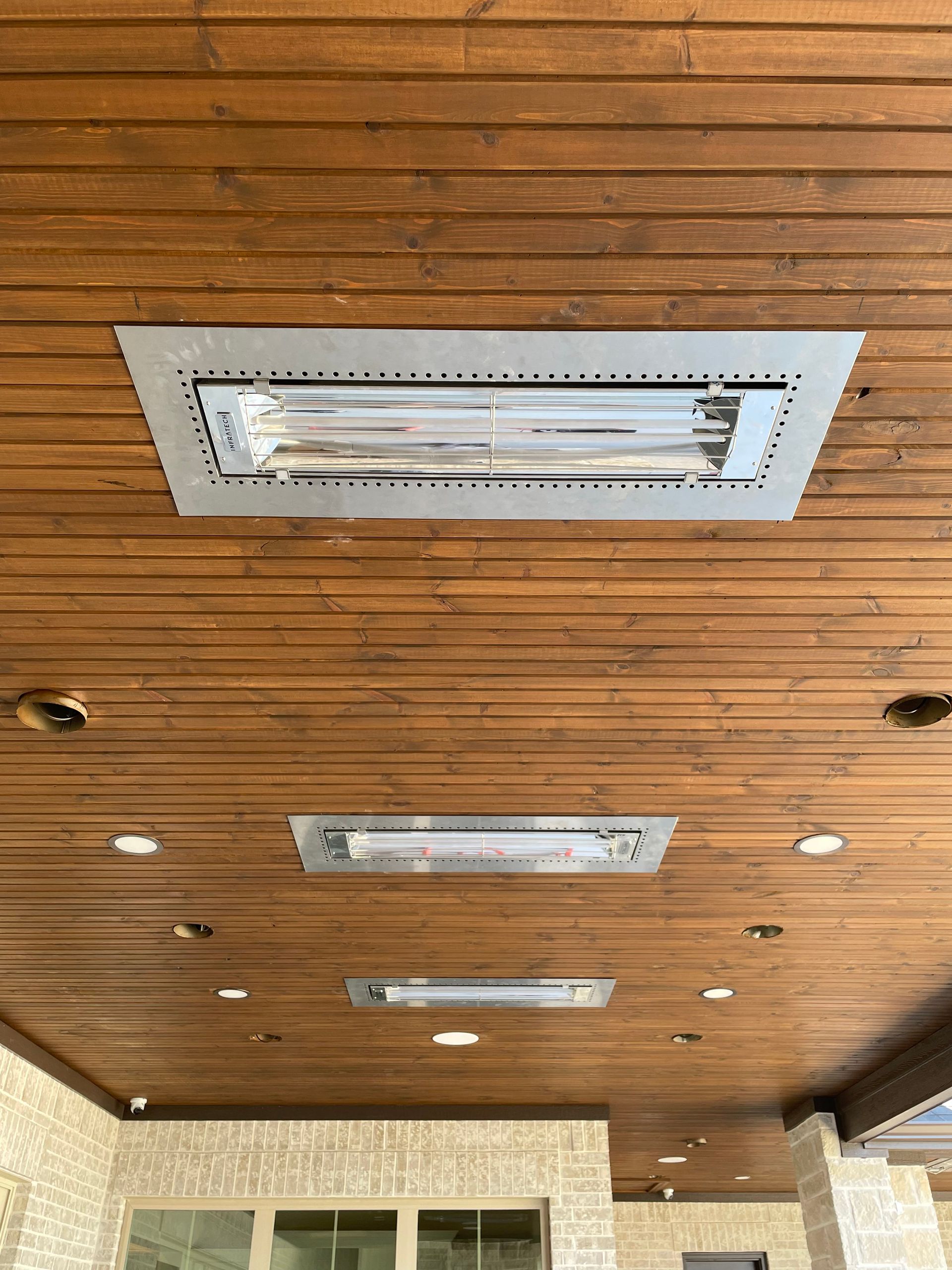 A wooden ceiling with a light hanging from it.
