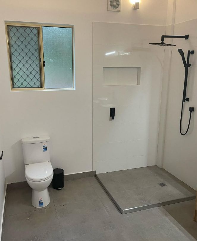 A Bathroom With a Toilet and a Walk in Shower — Plumbtek Solutions In Mudgeeraba, QLD