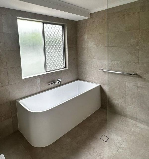 A Walk in Shower With a Hand Rail and a Shower Head — Plumbtek Solutions In Mudgeeraba, QLD