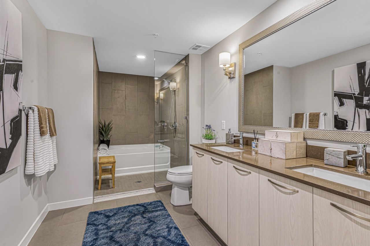 Modern bathroom with a double-sink vanity, glass shower, and soaking tub.