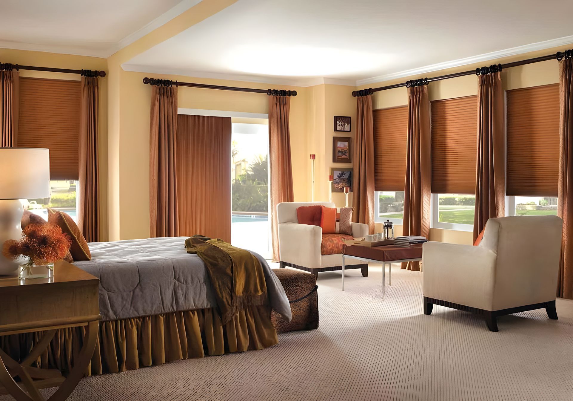 A bedroom with a bed, chair, and cellular shades on the window.
