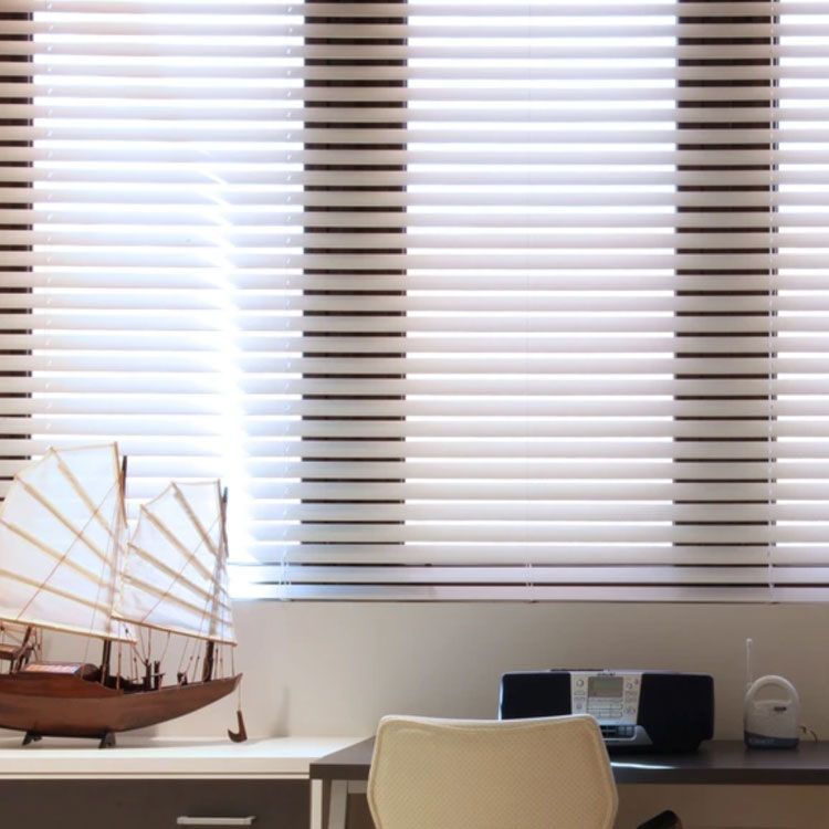 window wood faux blinds with boat and desk