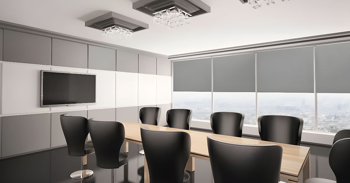 A roller shade boardroom with black chairs and a television.