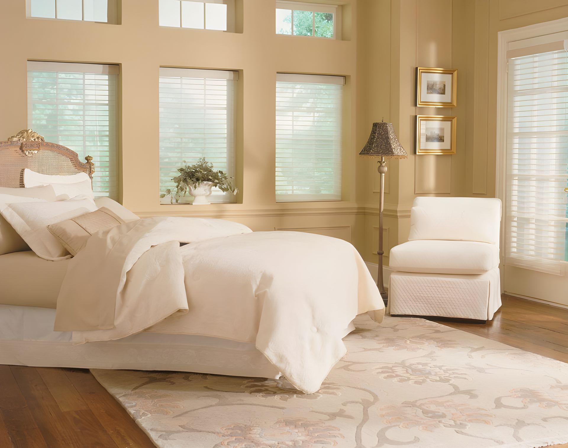 White comforter on bed with sheer shades windows