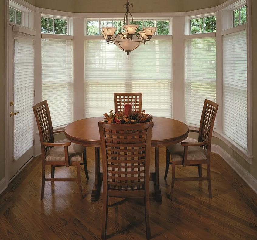A dining room with a round table and chairs