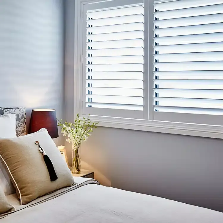 a bedroom with composite shutters
