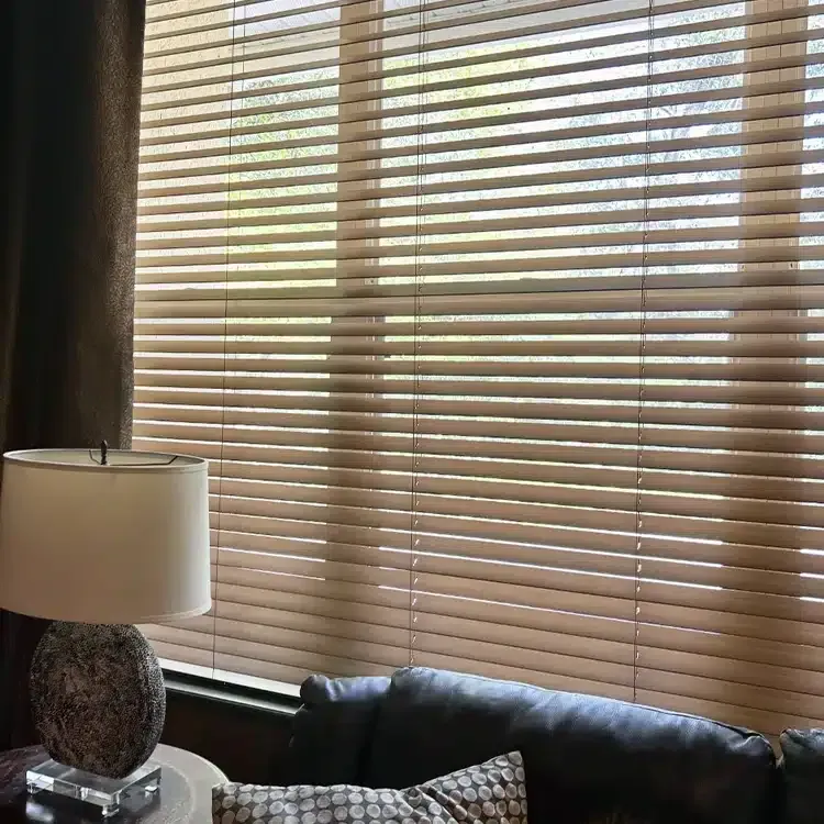 a wooden blinds hang on the bedroom window