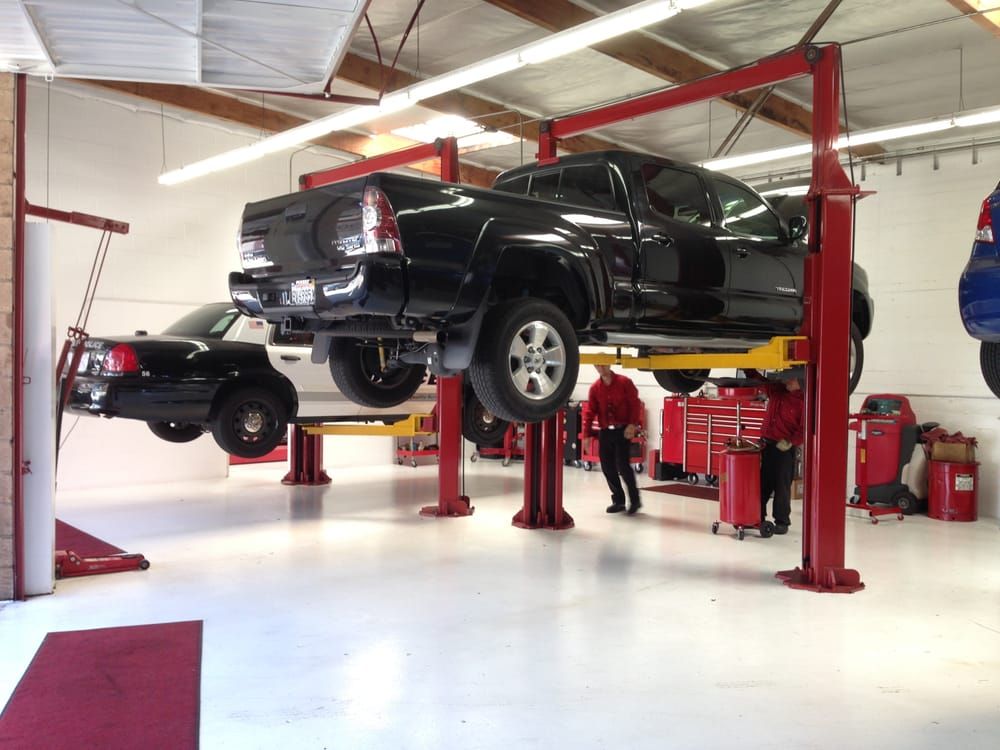 Truck on lift in garage | Ten-Four Auto