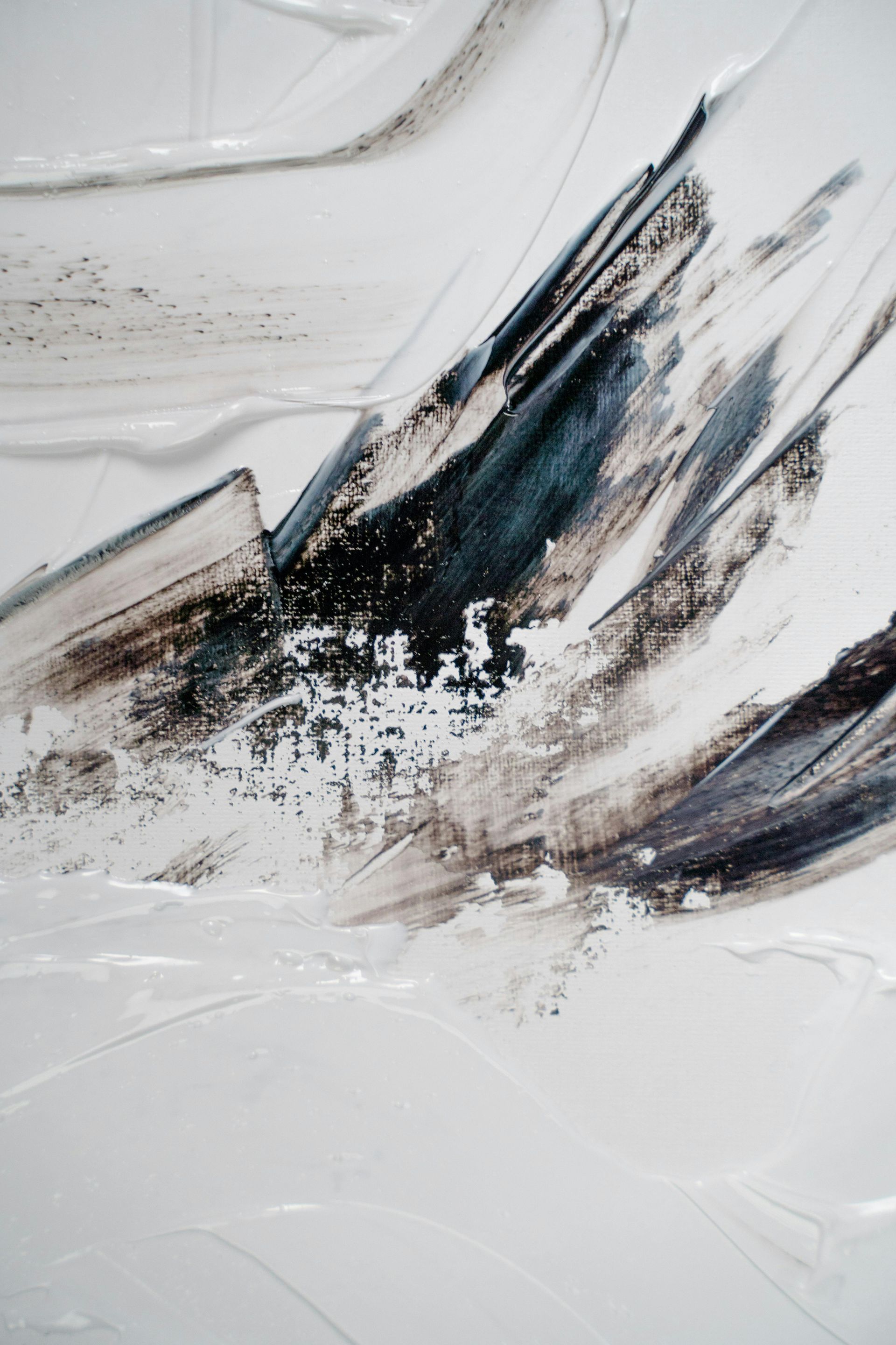 A close up of a black and white painting on a white surface.