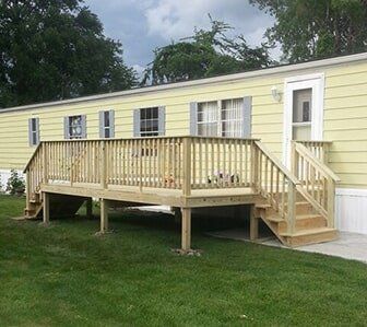 Yellow Mobile Home with Stairs  — Mobile Home Renovations in Crete, IL